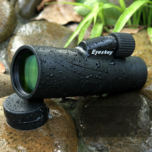 Black waterproof monocular telescope with front lens and grip ring, wet surface