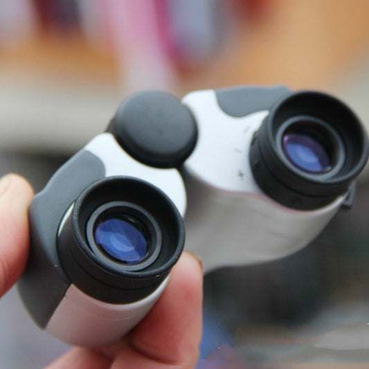 White-and-black Nikula binoculars with dual objective lenses and blue-tinted optics