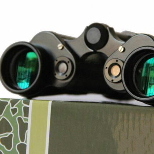Black binoculars front view with two green-tinted objective lenses