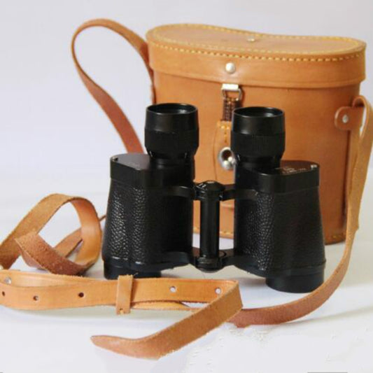 Black night-vision binoculars with brown carrying case, open