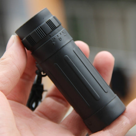 Compact monocular telescope in black with top focus wheel and side controls