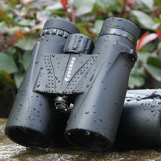 Dark gray waterproof binoculars with raindrop texture and central focus wheel