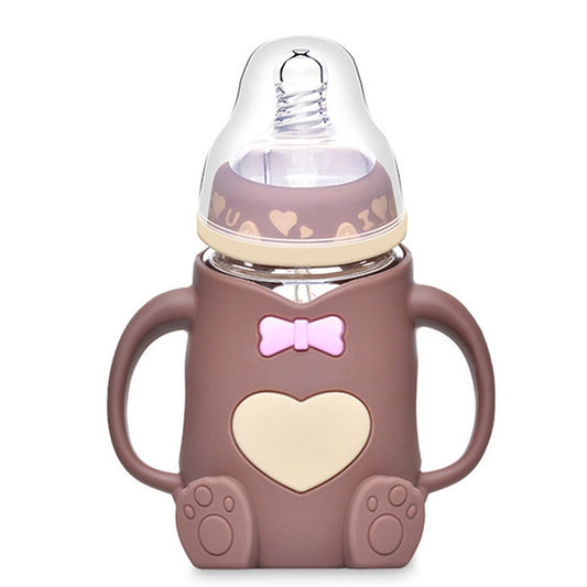 Brown baby silicone glass bottle with heart-and-bow front, clear nipple, and side handles
