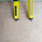 Yellow angle gauge with two measuring arms and metal scriber tips