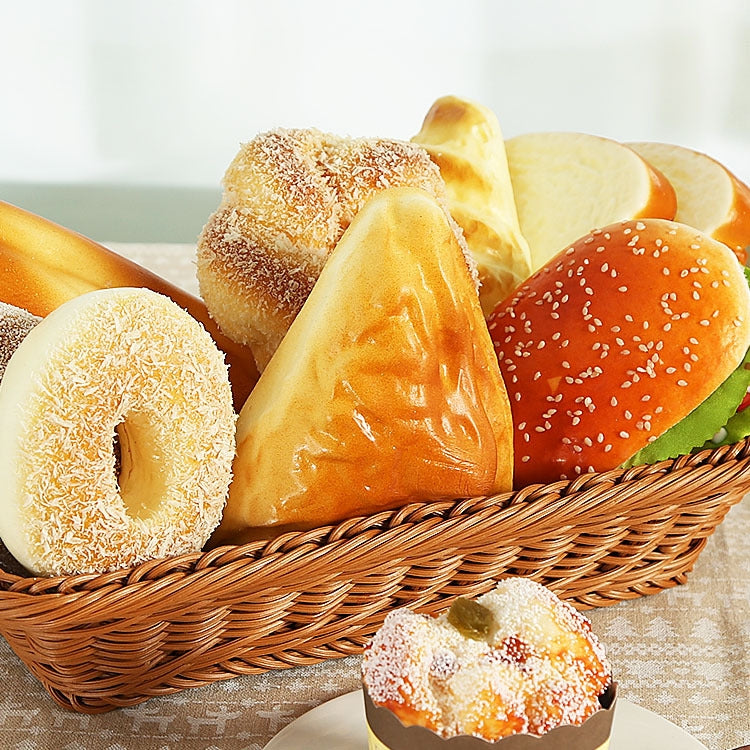 Wicker basket of mixed PU bread models: sesame bun, rolls, and loaf pieces