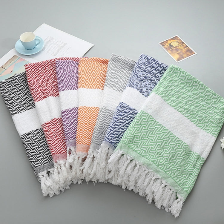 Assorted zigzag striped cotton bath towels with tassel fringe, folded together