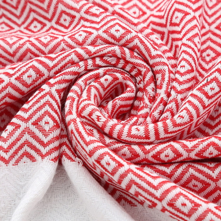 Close-up of red-and-white zigzag cotton towel fabric with soft woven texture