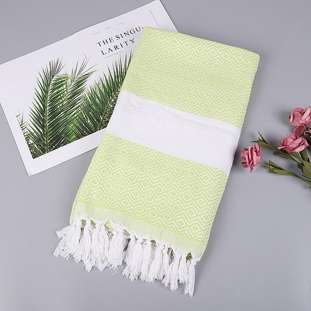 Cotton bath towel with light green zigzag pattern, white band, and tassel fringe