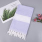 Cotton bath towel with purple zigzag pattern, white band, and tassel fringe