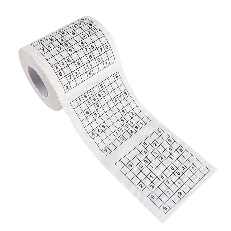 White toilet paper roll with sudoku puzzle paper unrolled diagonally
