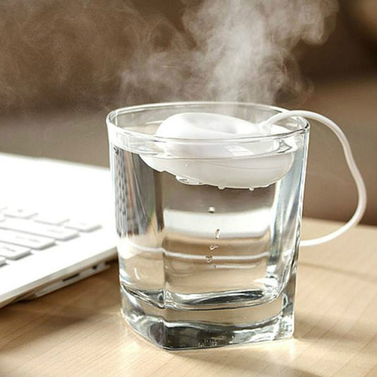 Mini USB donut-shaped humidifier with white cable, producing mist in a glass cup