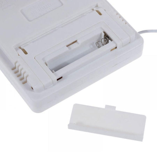 Indoor/outdoor electronic thermometer battery compartment open on a white plastic housing.