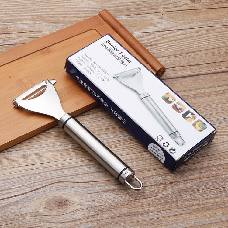 Stainless steel vegetable peeler pair with package box on wooden cutting board