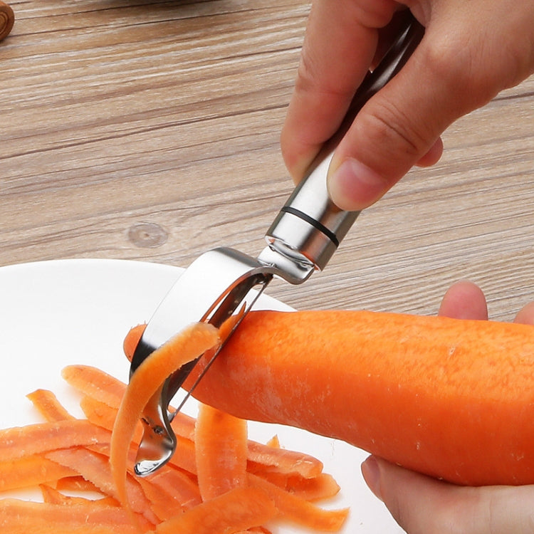 Bow planer stainless steel vegetable peeler shaving carrots into thin strips
