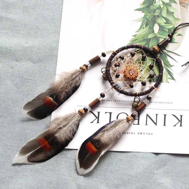 Single-ring dream catcher with beaded frame and three gray-brown feathers