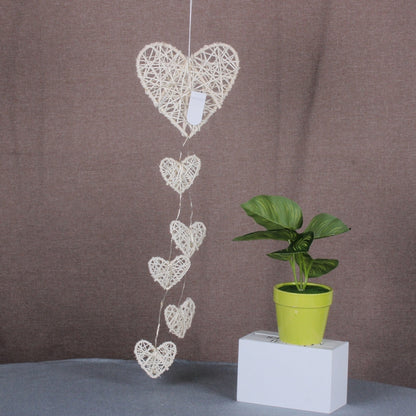 Rattan heart bell hanging ornament with multiple white-wash hearts on string