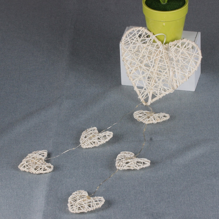 Rattan heart bell ornament cluster with three heart shapes on dangling cord