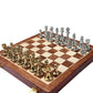 Chess set board with gold and silver metal pieces arranged for play