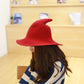 Red wool wizard hat with wide brim and tall pointed crown worn by model