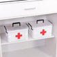 White plastic emergency medicine box with red cross stored on cabinet shelf