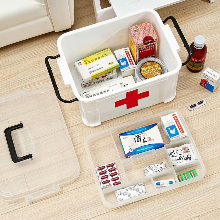 White medical emergency box with red cross open compartments holding assorted medicines