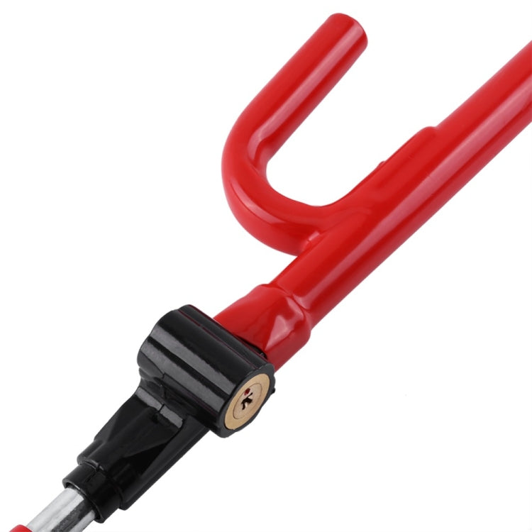 Close-up of red steering wheel lock bar with black clamp and key cylinder