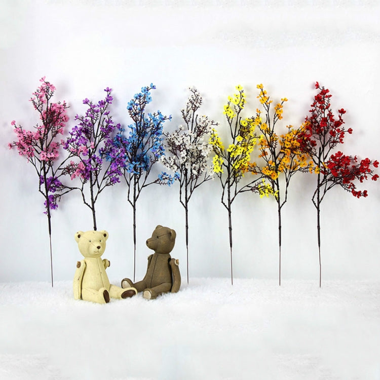 Colorful artificial blossom branch set with bear figurines in clear vases