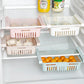 White refrigerator drawer shelves with eggs and fruit in separate vented baskets