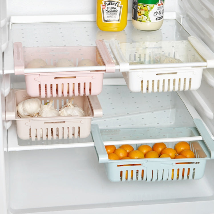 White refrigerator drawer shelves with eggs and fruit in separate vented baskets