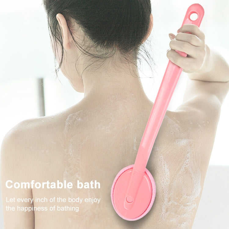 Pink back brush held against bare shoulders for single-sided body scrubbing