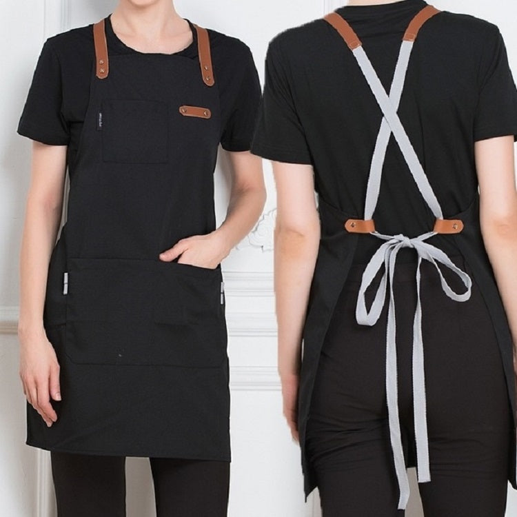 Black canvas apron with brown straps, X-back waist tie, front chest pocket