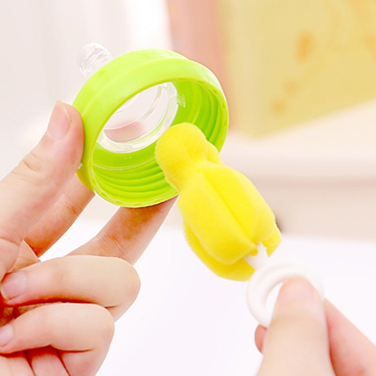 Green bottle brush cap with yellow sponge brush attachment, held in hands