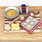 Mini wooden chopping board with toy food set: bread slices, eggs, and metal tray