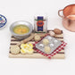 Mini wooden chopping board with toy dessert ingredients and blister egg tray