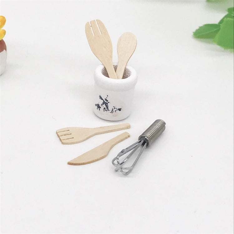 Mini kitchen utensil set with white crock holding wooden spatulas and whisk
