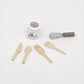 Mini kitchen utensil set: white crock, metal whisk, and four wooden spatulas