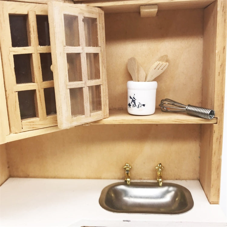 Mini dollhouse kitchen utensil set on open shelf: crock, wooden spatulas, whisk