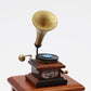 Front view mini retro gramophone toy with black record and brass horn