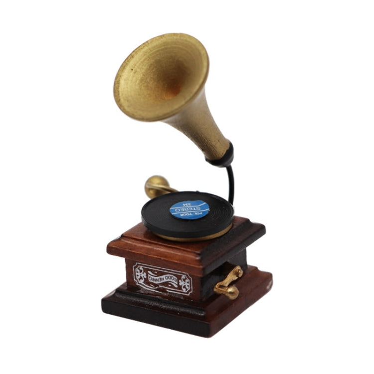 Mini retro gramophone toy close-up with brass horn and black record
