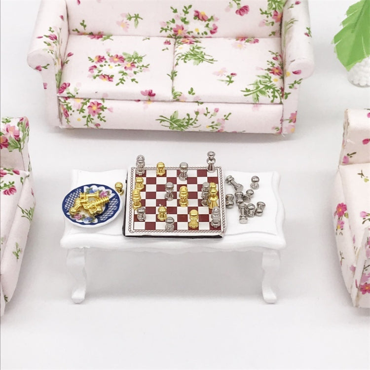 Miniature chess set accessory with red-and-white checkered board and gold/silver figures