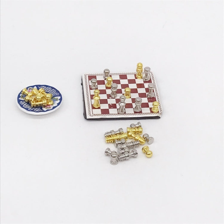 Miniature chessboard with gold and silver chess pieces plus small extra piece parts
