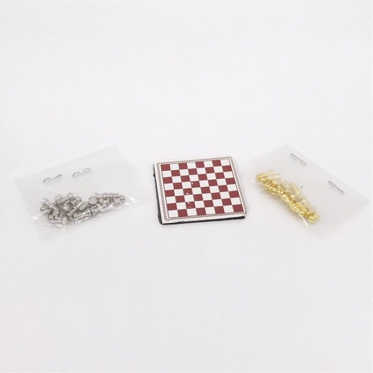 Miniature chess set accessory: red-and-white board with pieces in small clear bags