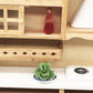 Mini faux cabbage toy on small blue-and-white plate inside dollhouse shelf