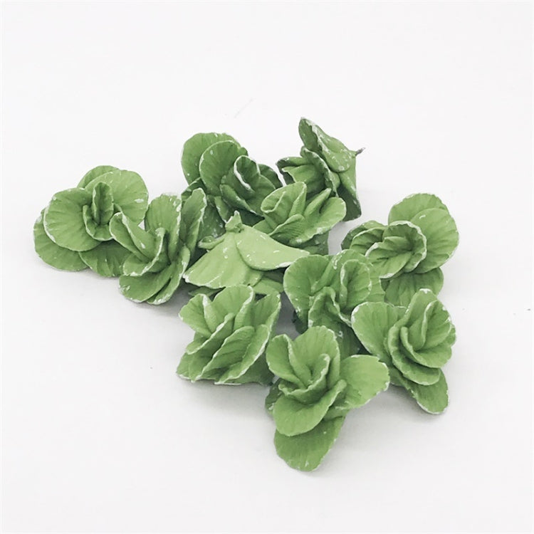Mini faux cabbage toy pieces scattered, bright green curled leaf rosettes