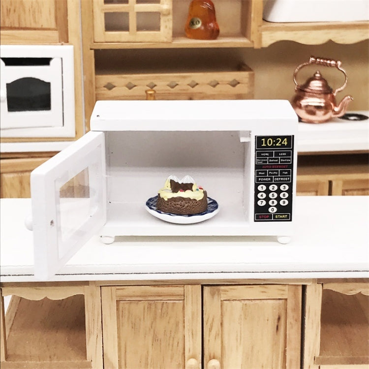 White dollhouse microwave oven with open door revealing a small plate inside