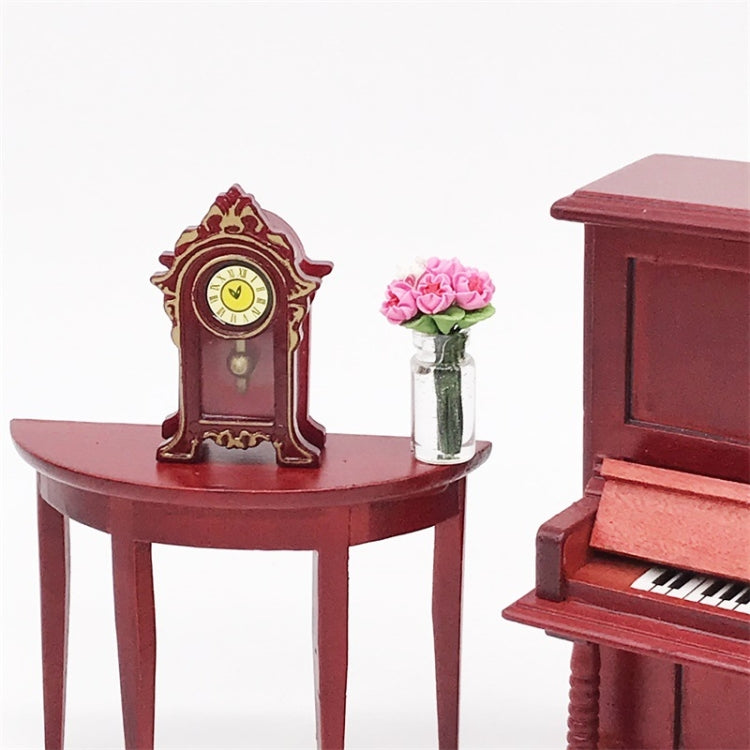 Mini vintage toy clock on red round table, yellow clock face with golden Roman numerals