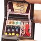 Close-up of mini wooden sewing box interior with scissors, spools, and buttons