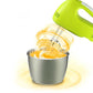 Electric hand mixer with stand, green head mixing batter in stainless bowl
