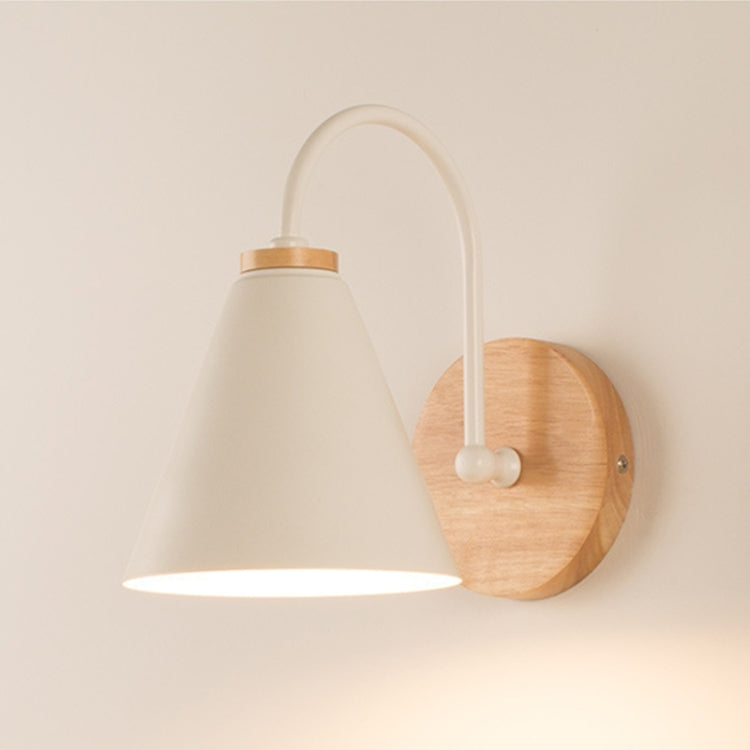 LED wall bedside lamp with white fabric shade and round wood backplate on an arched white arm