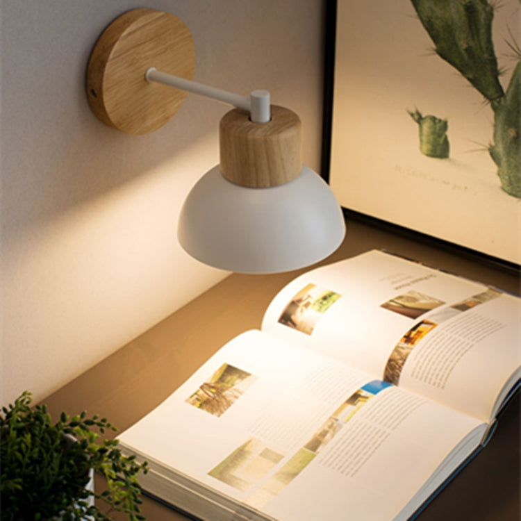 Wall bedside lamp with gray fabric shade, round wood backplate, and white metal arm